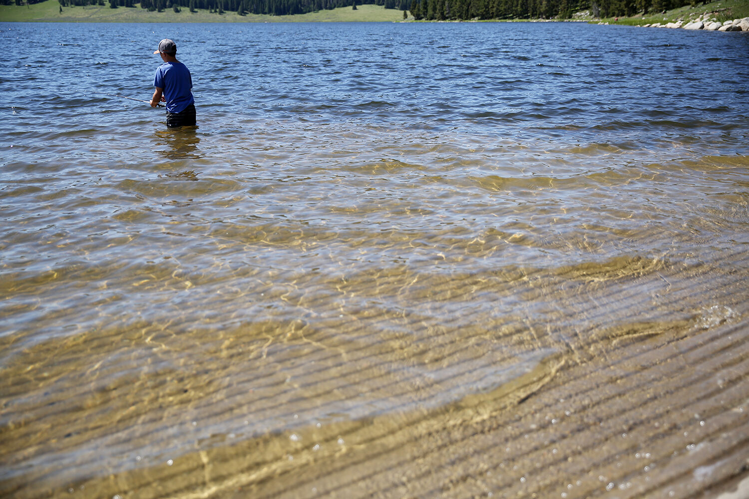 Henry Shoup tries his luck fishing from the edge of the boat ramp